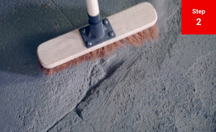 A brush sweeping a crack